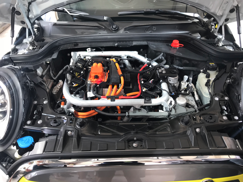 Under the hood and with the engine cover gone, you can see the electric motor and inverter.